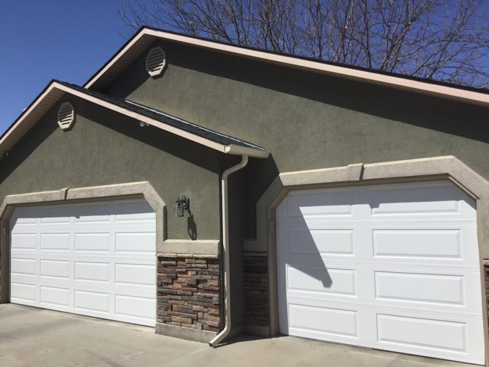White traditional garage doors with long panels.