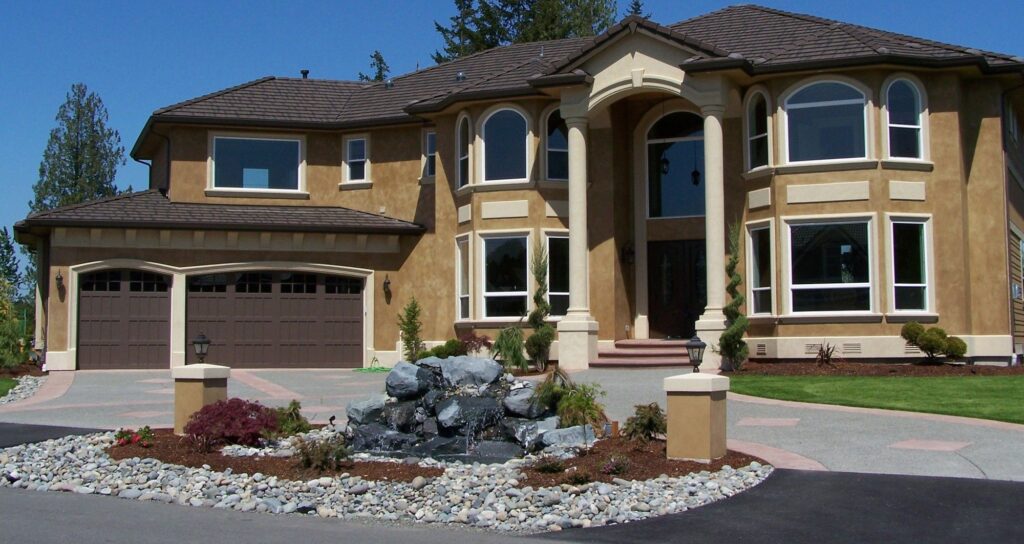 Mansion with brown carriage garage doors